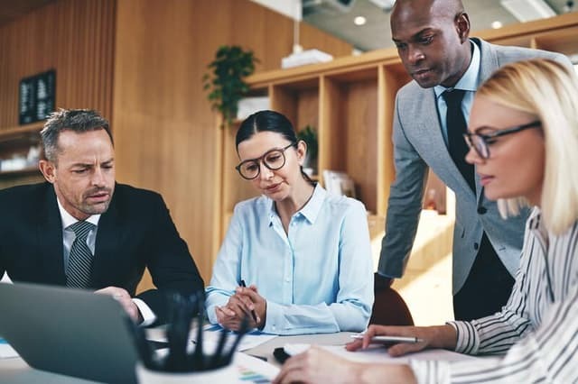 webimage-Diverse-businesspeople-going-over-paperwork-together-during-an-o