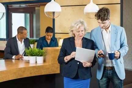 Web_Desktop-Businesspeople Discussing On Paperwork At Office